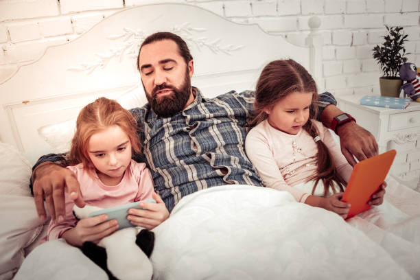 istock Nice young girls playing on their devices 1082573226