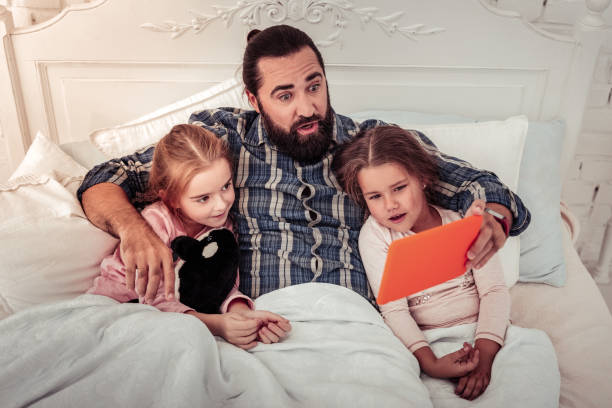 istock Pleasant bearded man looking at the tablet screen 1082573228