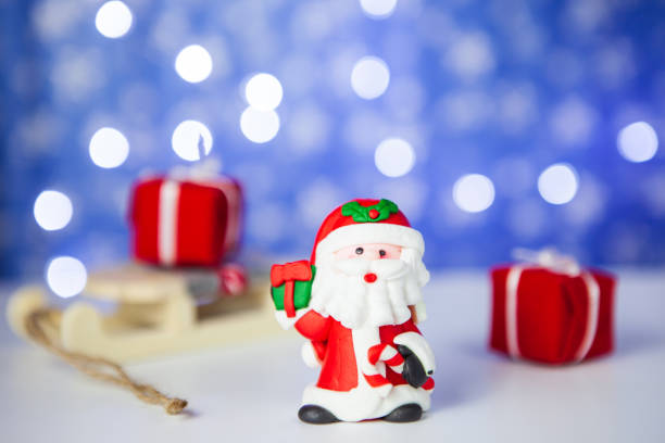 istock Gift boxes on sleigh and Santa on blue background 1082576808