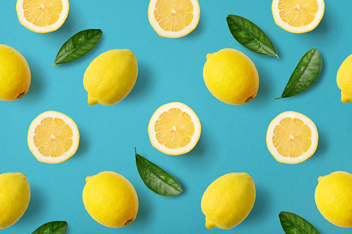 Colorful fruit pattern of lemons on blue background, top view