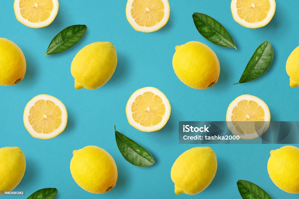 Colorful fruit pattern of lemons Colorful fruit pattern of lemons on blue background, top view Lemon - Fruit Stock Photo