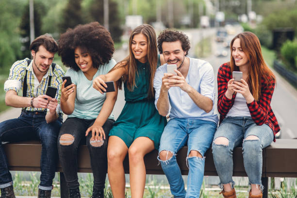 istock Happy friends using smartphones 1082582740