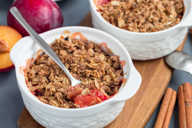 istock Plum crumble pie or plum crisp with oats and spices, in baking dish, horizontal 1082584062