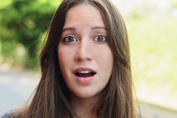 istock Young woman with surprised expression. Outdoor. 1082586528