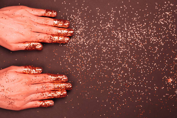 istock Manicure with glittering Living Coral fingers. 1082589638