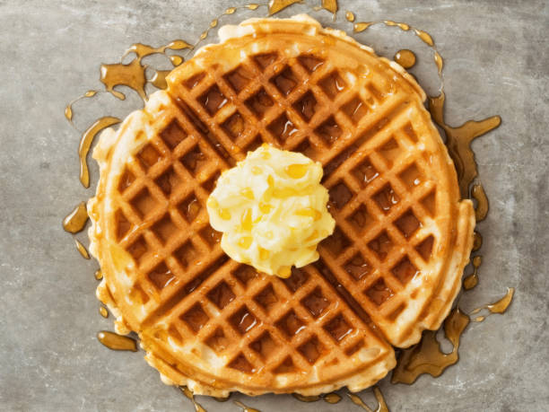 istock rustic traditional waffle with butter and maple syrup 1082589676