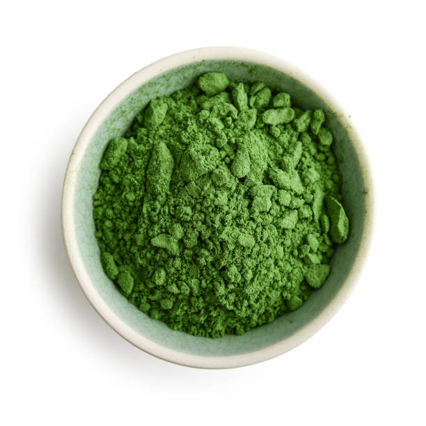 Bowl of spirulina powder Bowl of spirulina powder isolated on white background, top view chlorella stock pictures, royalty-free photos & images