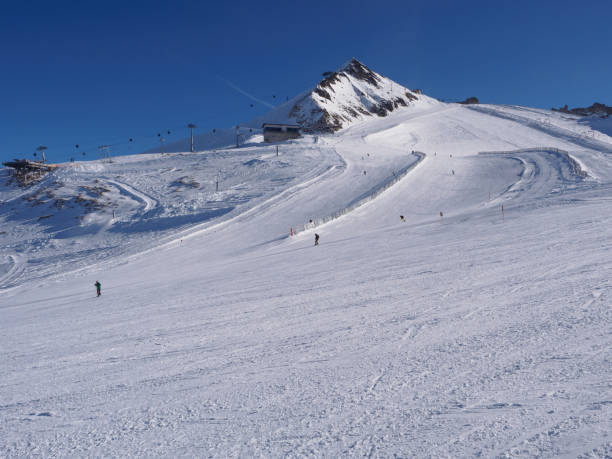 istock Skiers descending from high peak 1082609328