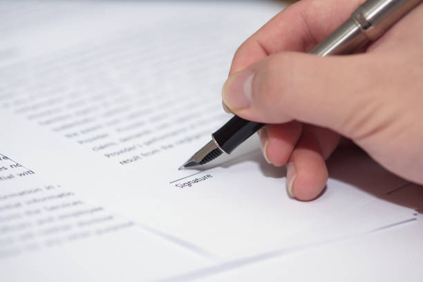 istock Close up of hand writing on contract 1082609516