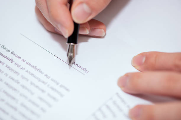 istock Close up of hand writing on contract 1082609630