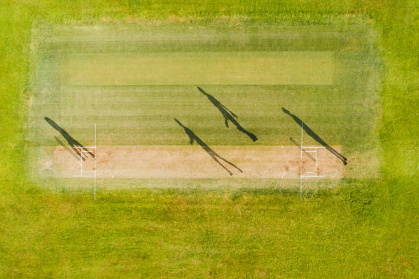 istock Shadow of cricket players in ground. 1082611444