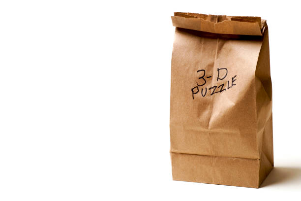 istock Wooden 3-D Puzzle and Paper Bag 1082614694