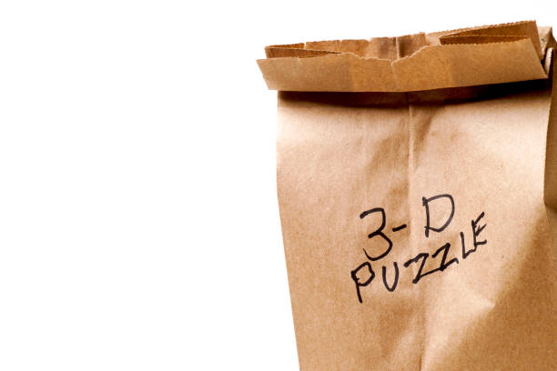 istock Wooden 3-D Puzzle and Paper Bag 1082614698
