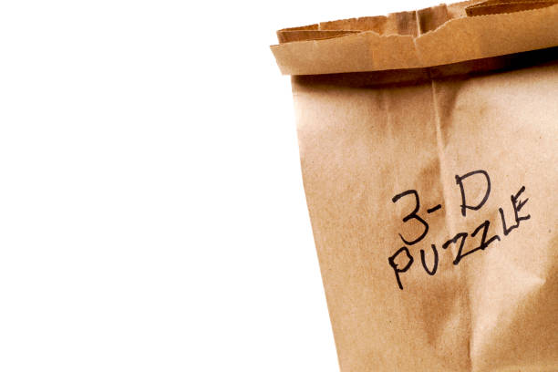 istock Wooden 3-D Puzzle and Paper Bag 1082614704