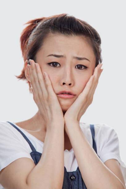istock Sad Asian woman with head in hands 1082622888