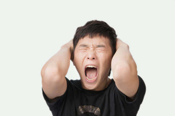 retrato de estúdio chinês homem gritando - confusion hand in hair tired touching - fotografias e filmes do acervo