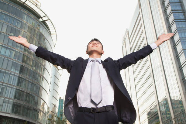 istock Happy businessman raising hands 1082641586