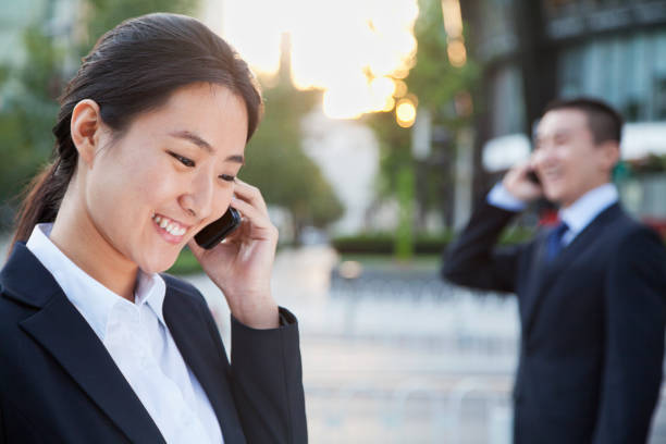 istock Chinese business people talking on cell phones 1082641676