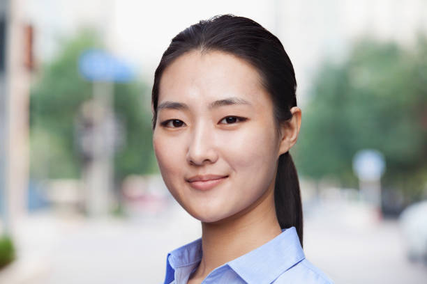 istock Chinese businesswoman looking above camera 1082645988