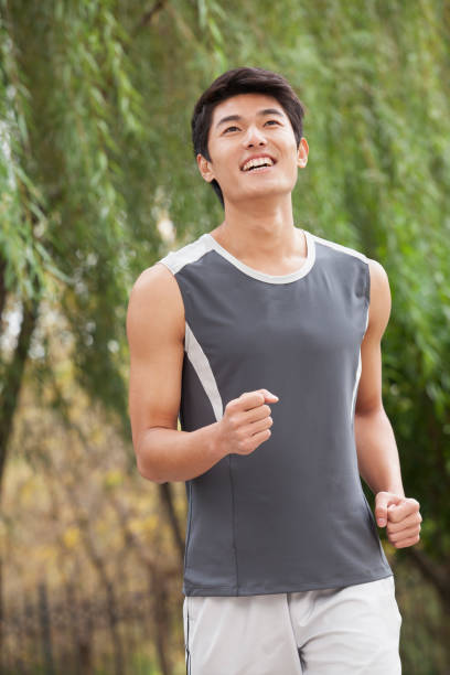 istock Chinese man running at the public park 1082651390