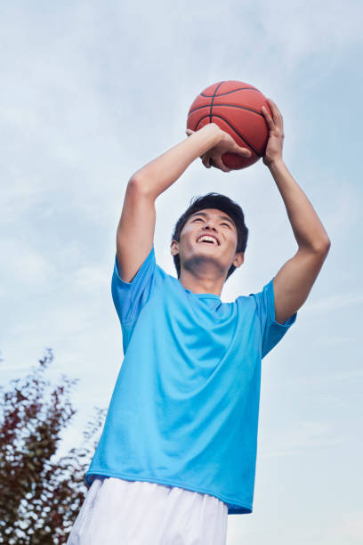 istock Chinese man playing basketball 1082651864