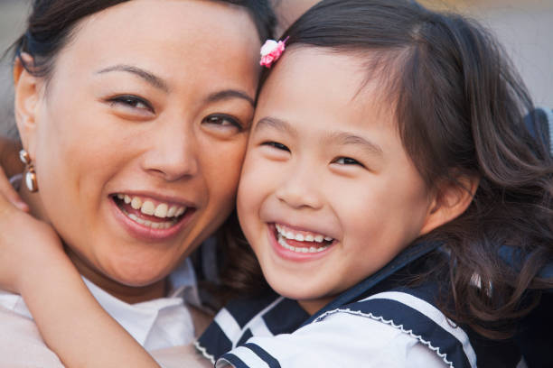 istock Smiling Chinese mother and daughter 1082659524