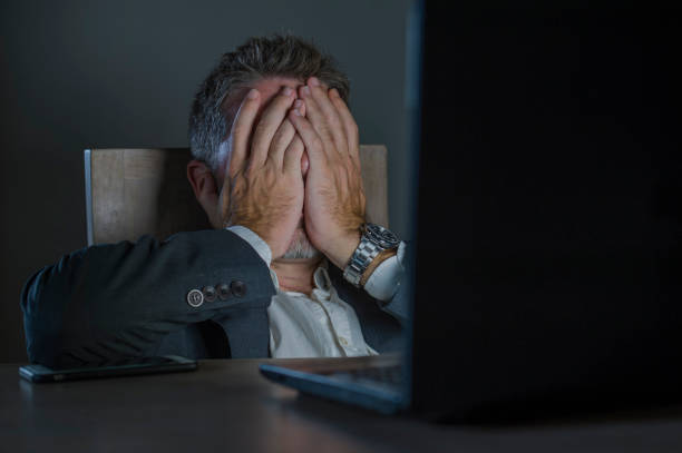 istock young desperate and stressed businessman working overtime at office laptop computer desk feeling anxious and overwhelmed suffering depression problem and anxiety crisis in business problem 1082670806
