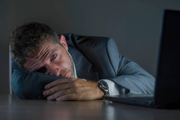 istock young desperate and stressed businessman working overtime at office laptop computer desk feeling anxious and overwhelmed suffering depression problem and anxiety crisis in business problem 1082670836
