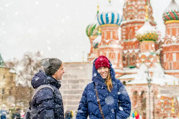 portrait of young lovers couple walking in the moscow historic city travel in europe during winter
