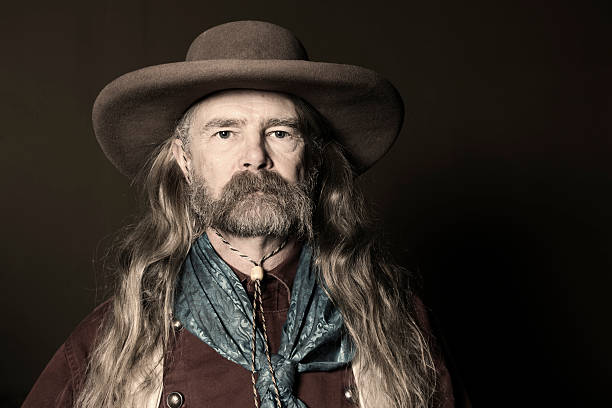 Portrait of Man With Long Hair Wearing Cowboy Hat stock photo