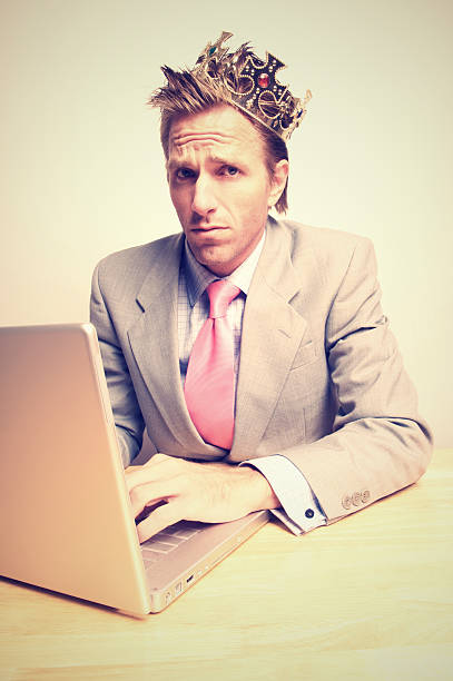 istock Businessman Wearing Crown and Working on Laptop 108267665