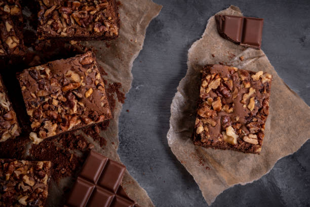 istock Sliced brownie cake on baking paper and chunks of chocolate 1082679422