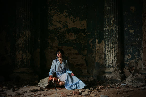 Woman sitting in abandoned house