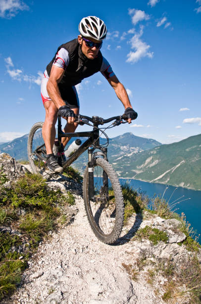 istock Man Mountain Biking on Trails Above Lake 108268055