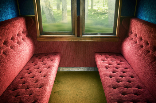 Old-fashioned train compartment interior in old railroad car.