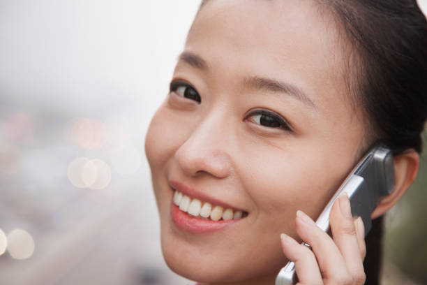 istock Chinese woman talking on cell phone 1082682398