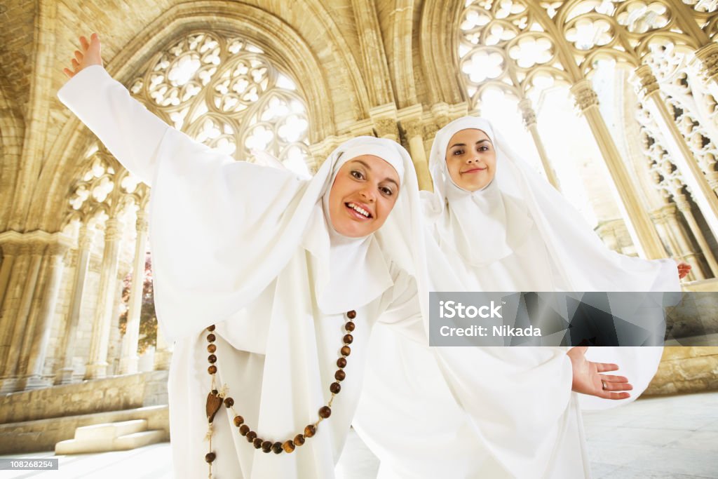 Nuns Dancing in Old Church Cathedral Two young nuns dancing in joy Nun Stock Photo