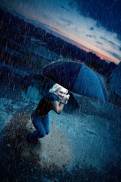 istock Beautiful blonde girl with umbrella under rain 108268570