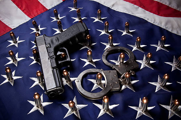 Pistol, handcuffs, bullets and flag (horizontal) stock photo