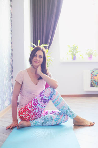 istock Young brunette woman practicing yoga at home. 1082686216