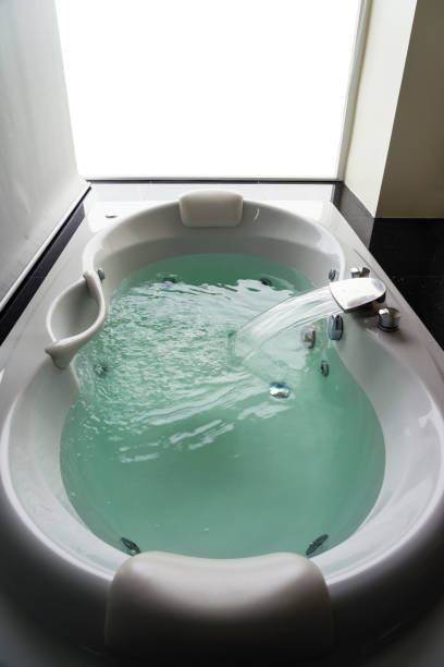 istock Empty white massaging jetted bathtub with turquoise water 1082686308
