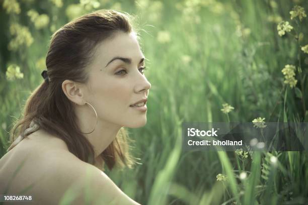 Young Woman Sitting In Green Field Meadow Stock Photo - Download Image Now - Summer, Adult, Adults Only