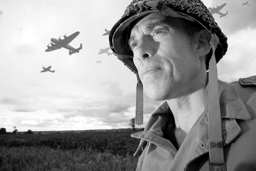 World War 2 soldier and planes invade Normandy, France. Photographed on location during the 65th anniversary of D Day. The planes were shot the same day and added to the photo.