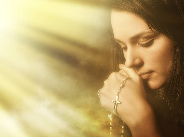 istock Praying young woman in light and incense smoke 108269062