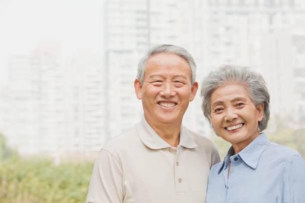 istock Smiling senior Chinese couple looking at camera 1082691958