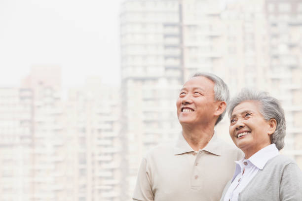 istock Smiling Chinese couple planning future 1082693026