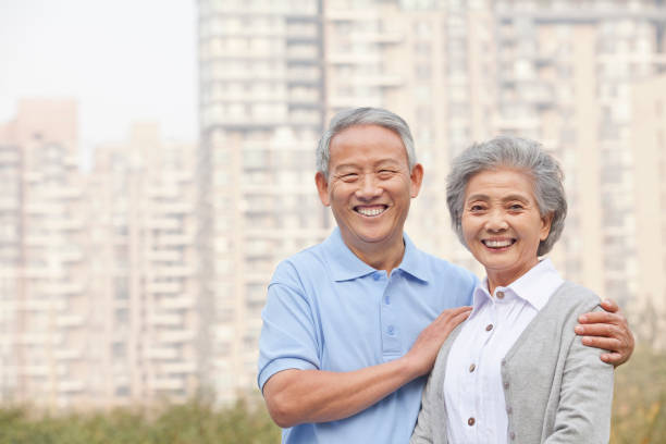 istock Smiling Chinese couple looking at camera 1082693074