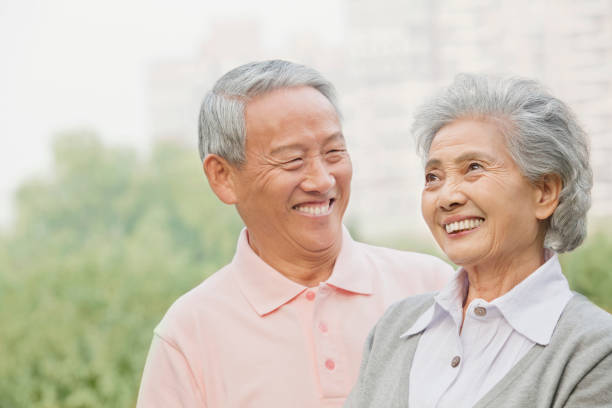 istock Smiling Chinese couple in public park 1082693266