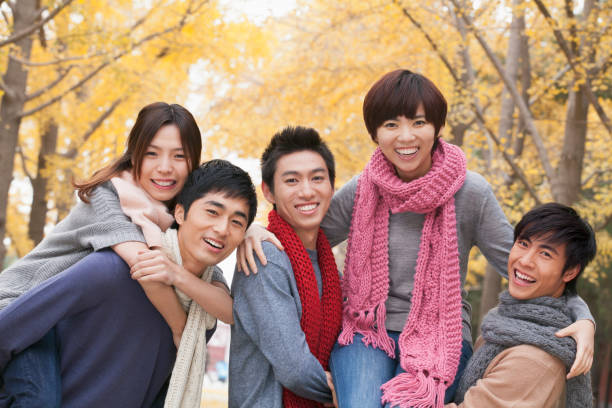 istock Smiling Chinese friends in park 1082694418