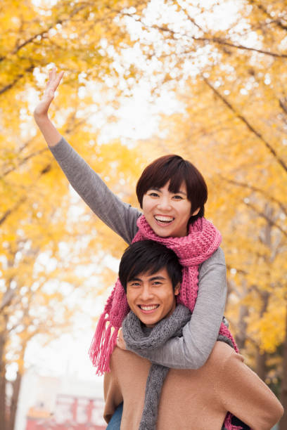 istock Chinese man giving girlfriend piggy back ride 1082694424